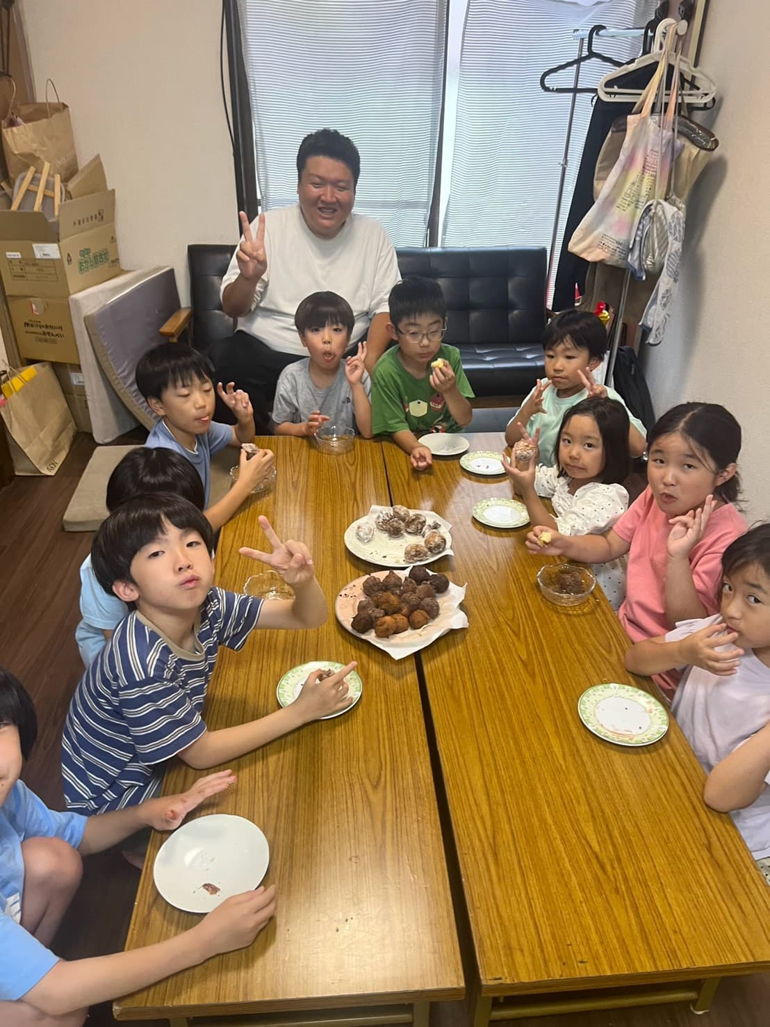 完成したドーナツを頬張るまどいっ子たち