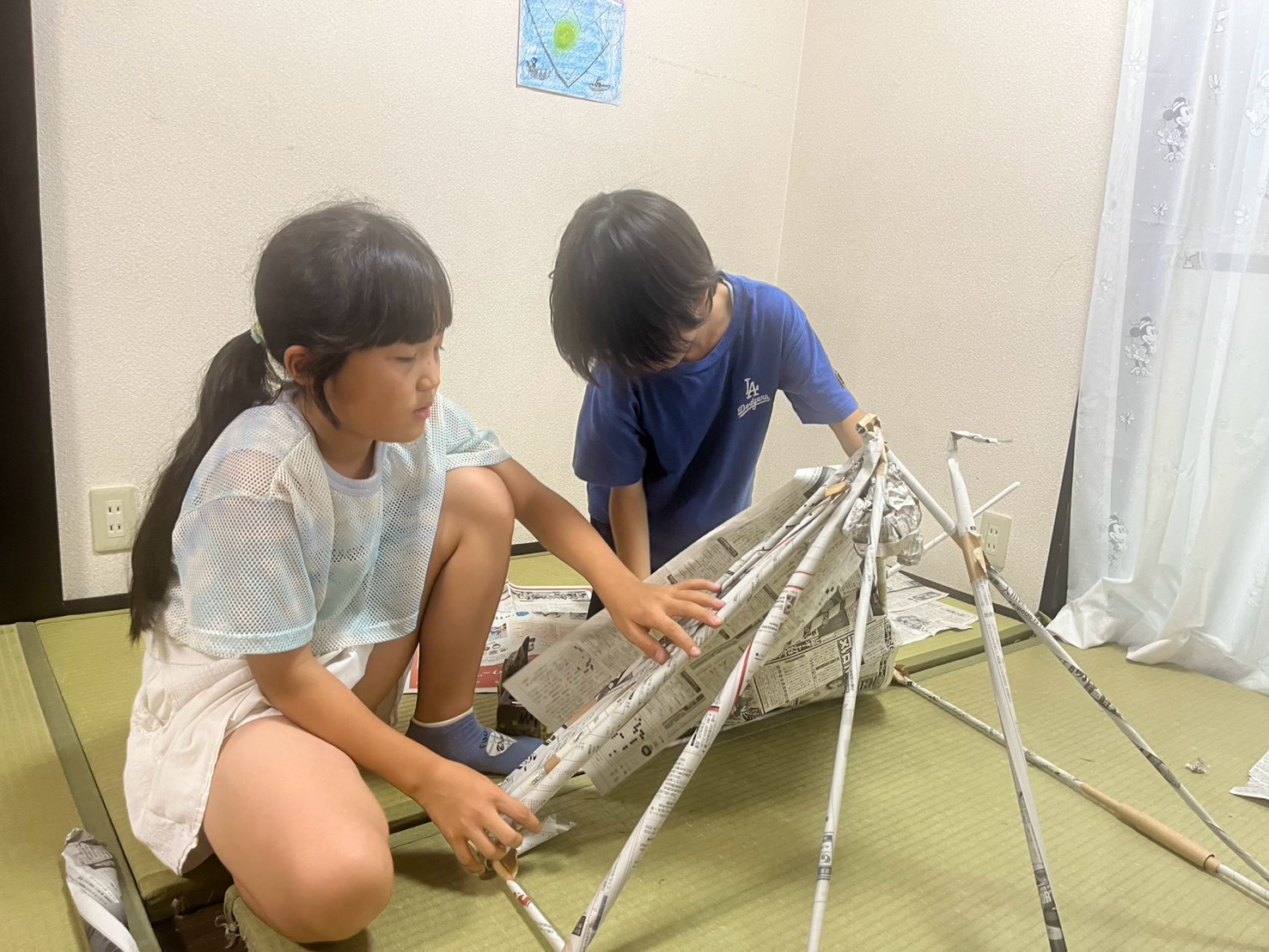 新聞紙を使ってタワーを作る子どもたち